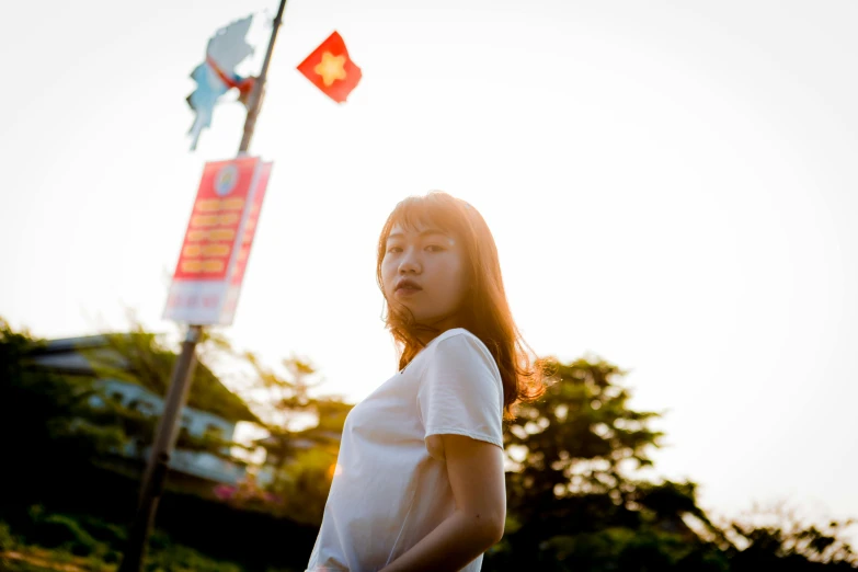 a woman standing next to a red and white traffic sign