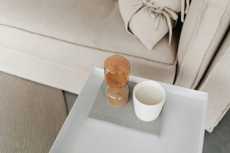 a glass table sitting next to a beige couch