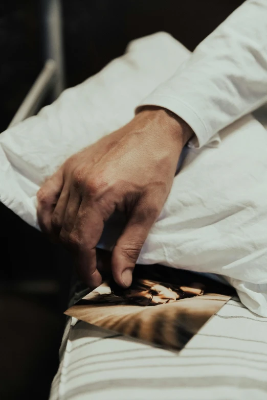 a man holding on to a poster as he rests