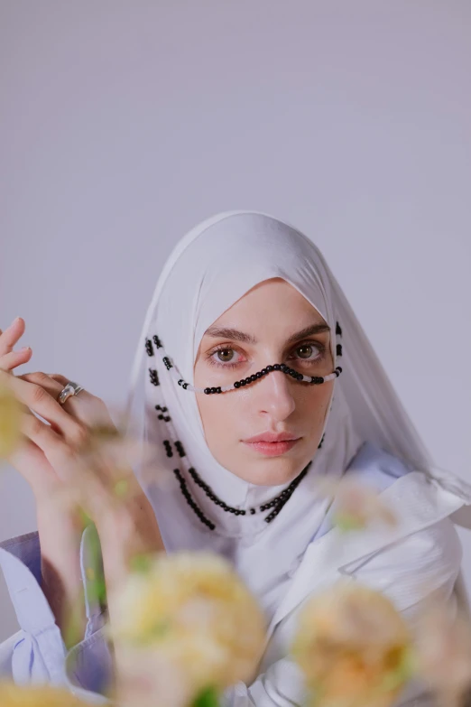 a woman with glasses has her hands in the air