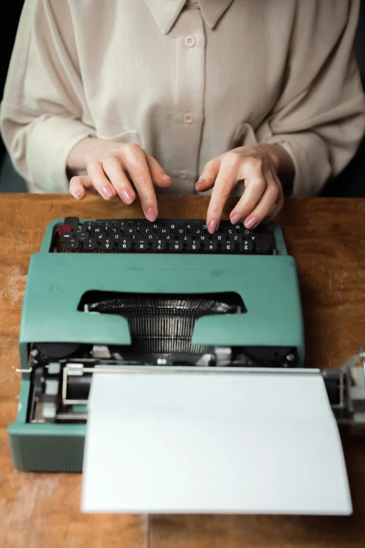 a woman working on a vintage typewriter in a home office