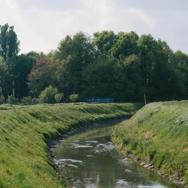 the view is looking towards the river near a pasture