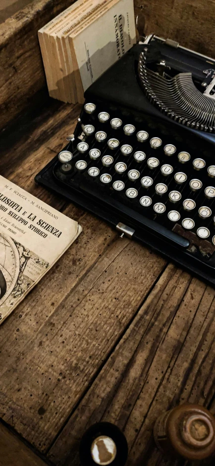 an old typewriter is shown sitting on a wooden table