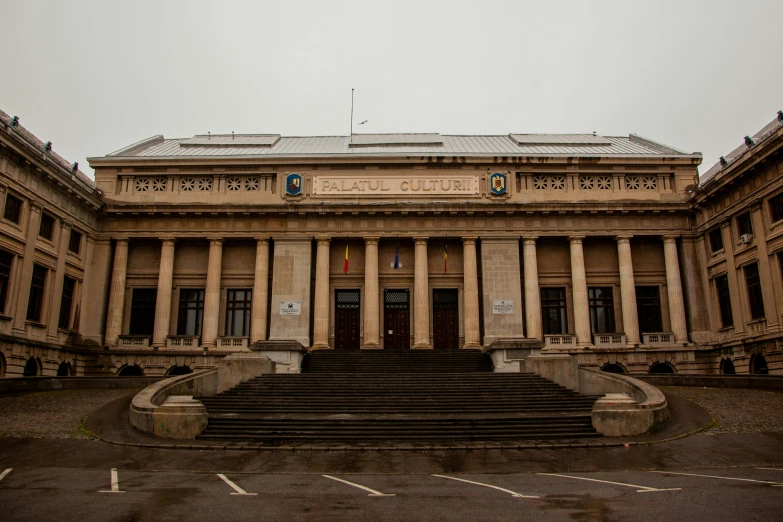 an old building with columns is on the corner