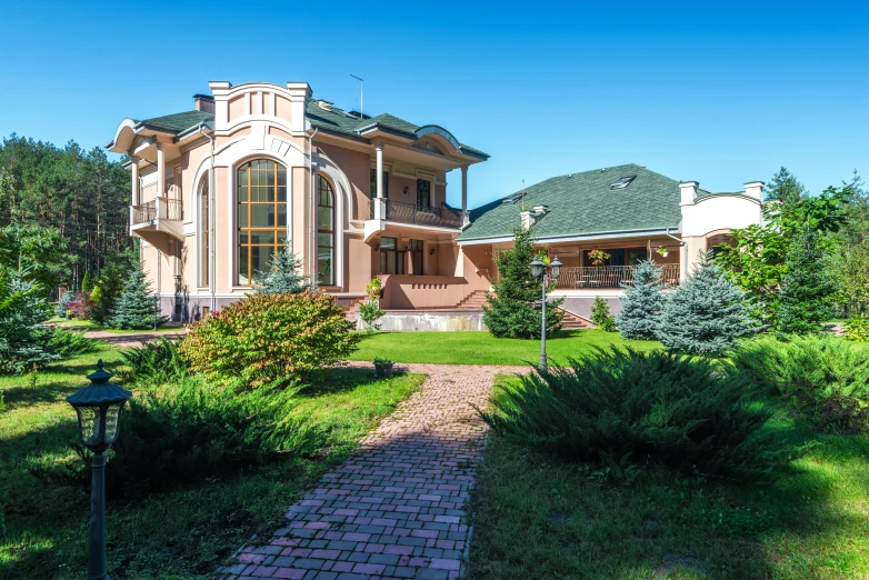 a large victorian revival house sitting in the middle of some grass