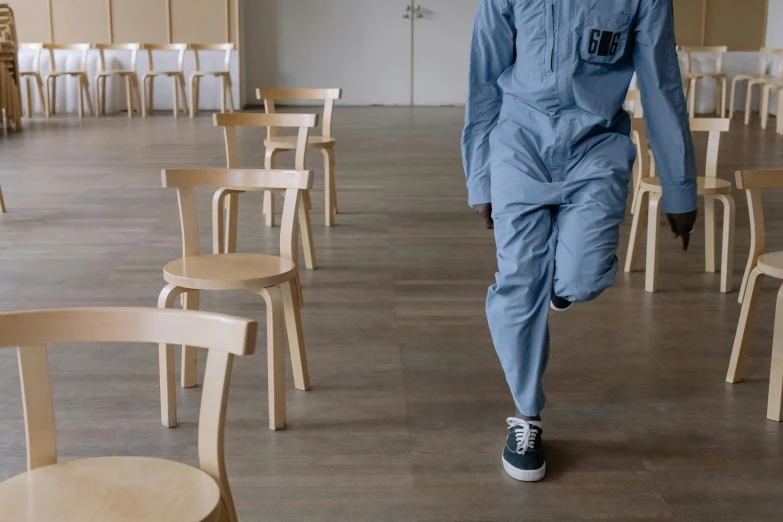 a man walking in a suit and chair display