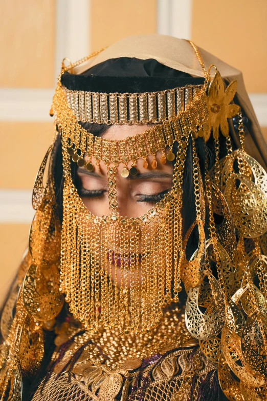 a woman with gold jewelry is wearing a costume