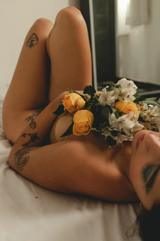 a women with a flower bouquet laying on her stomach