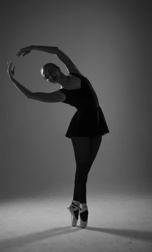 a female ballerina is standing in the air