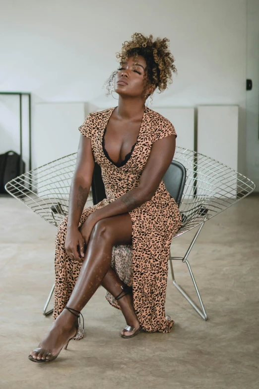 a black woman sitting on a chair