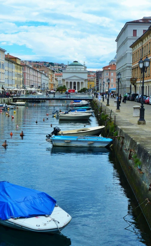 small boats floating on a body of water in a city