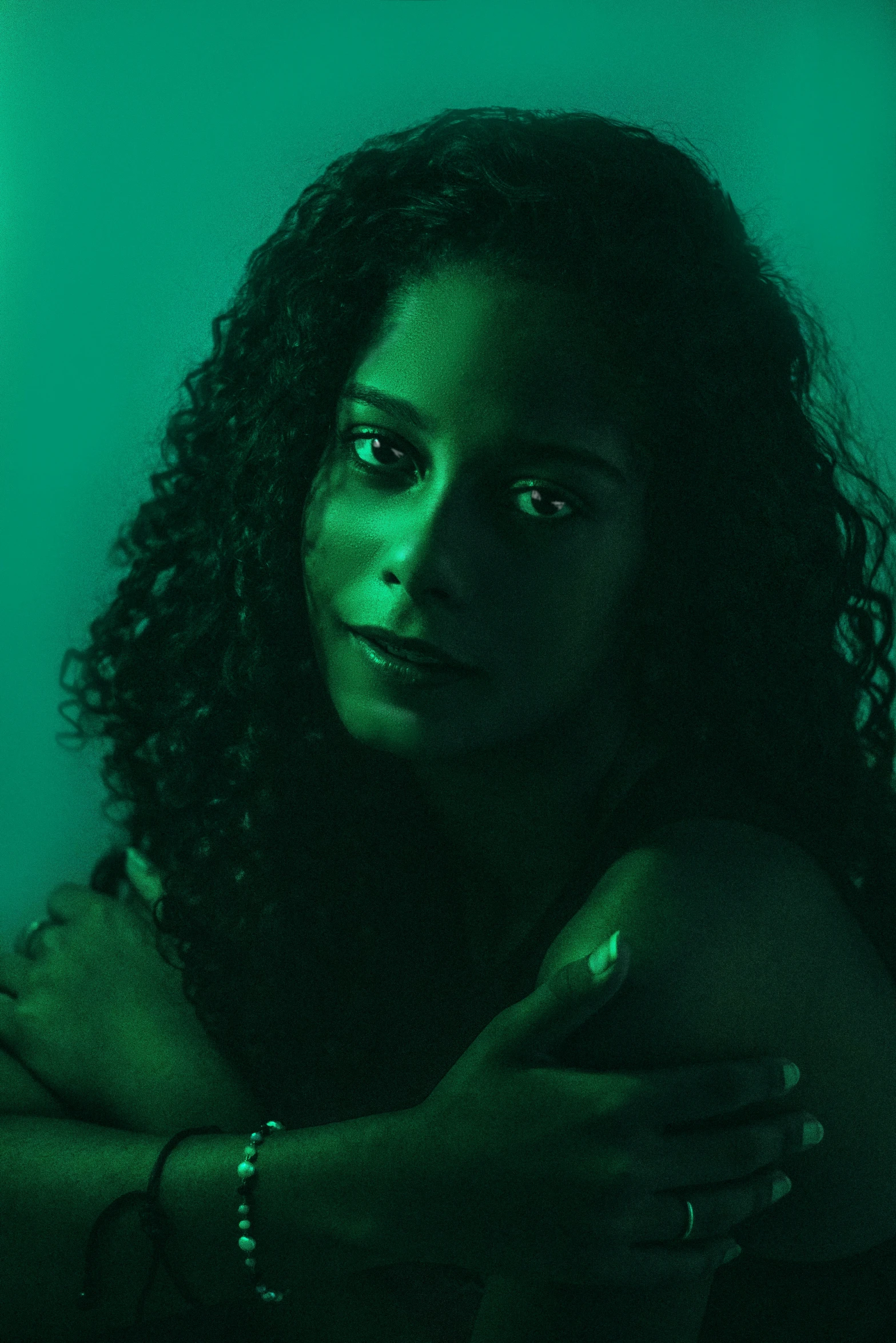 a dark image of a woman with curly hair