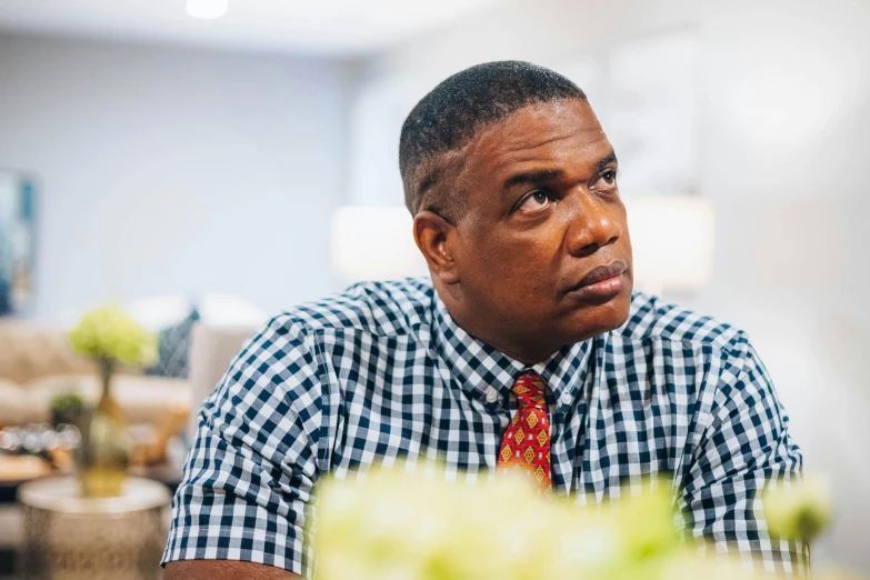 a man wearing a plaid shirt and a red tie