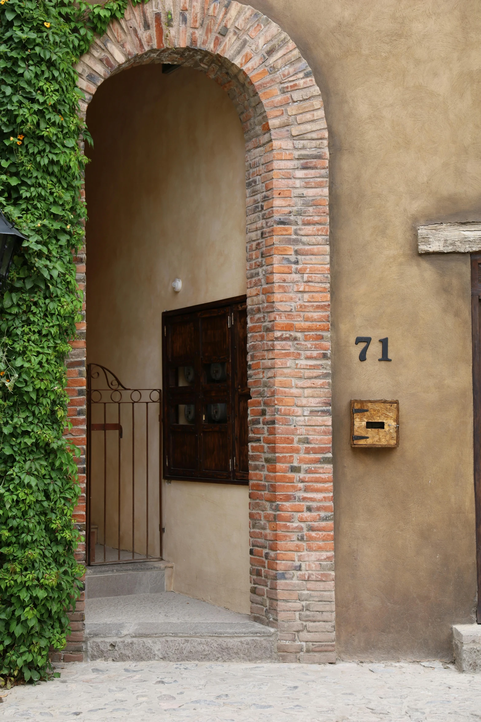 entrance with arched doorway leading to apartment building