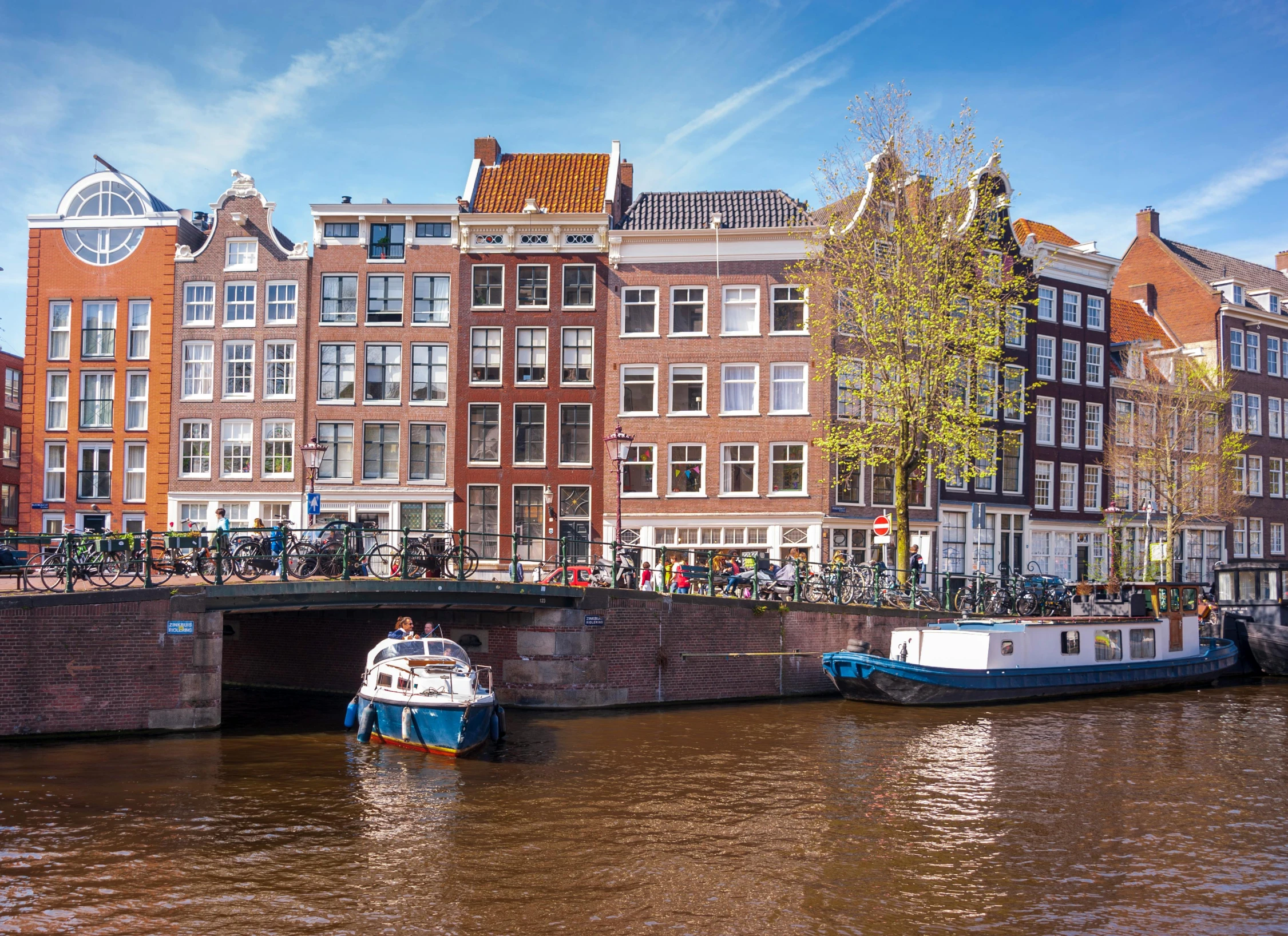 boats docked along side buildings on the canal