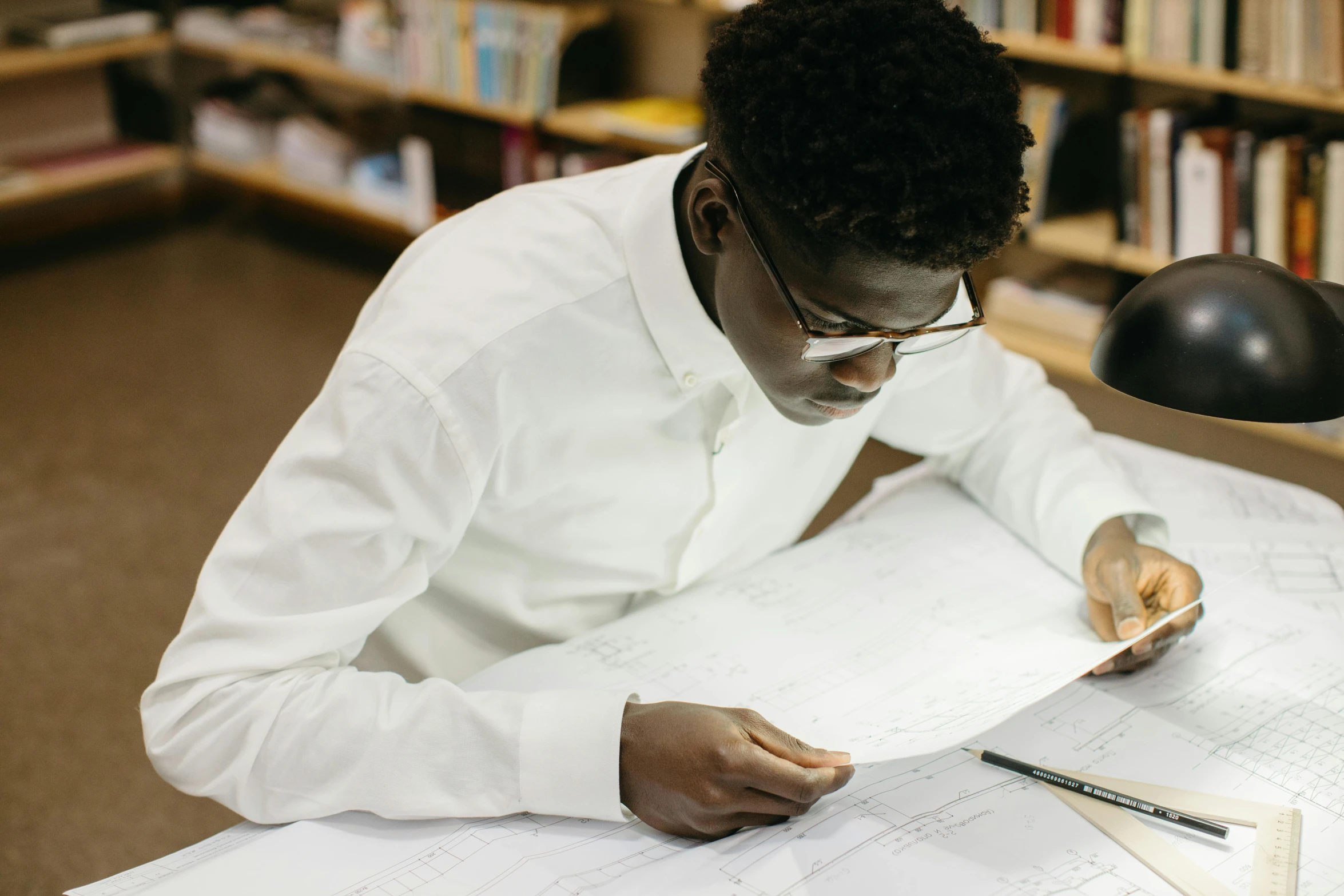 a person is writing soing on a sheet of paper