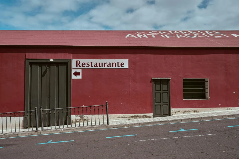 the side of an old restaurant building with red walls