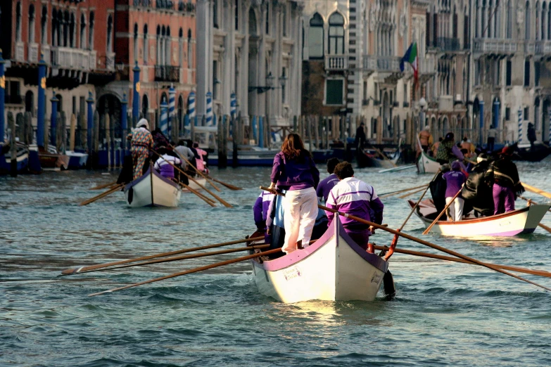 people in boats paddling down the river