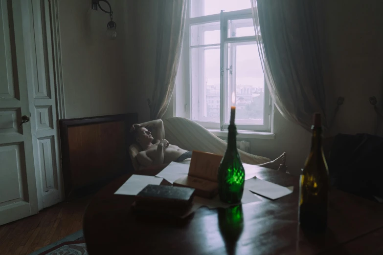 a room with a couch, table and bottle on the floor