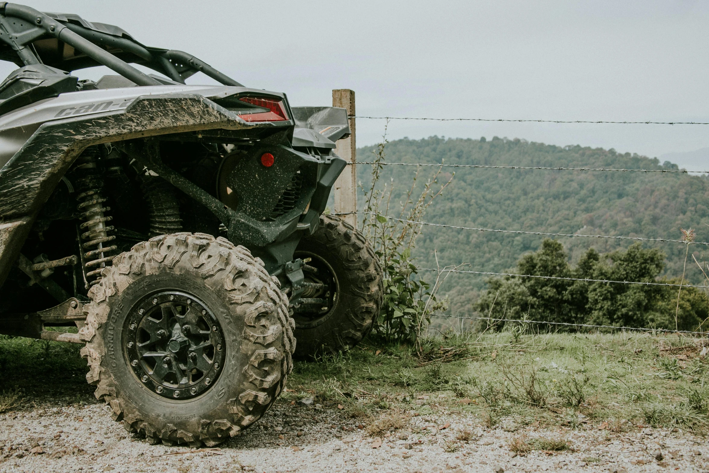 a side view of a can am spyder with huge tires