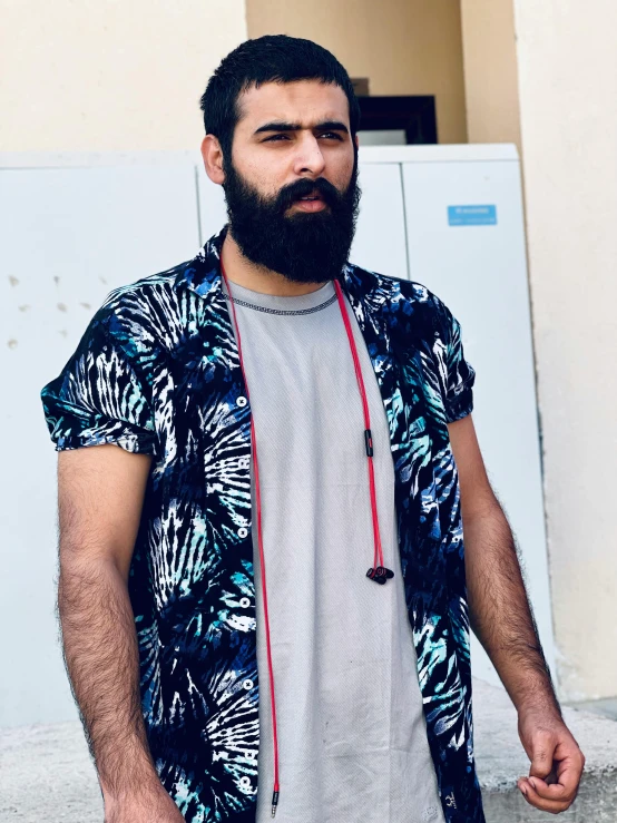 a man standing in front of a building wearing headphones