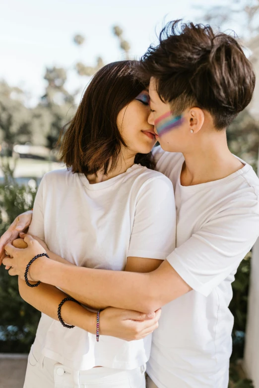 couple cuddling in close proximity and smiling at each other