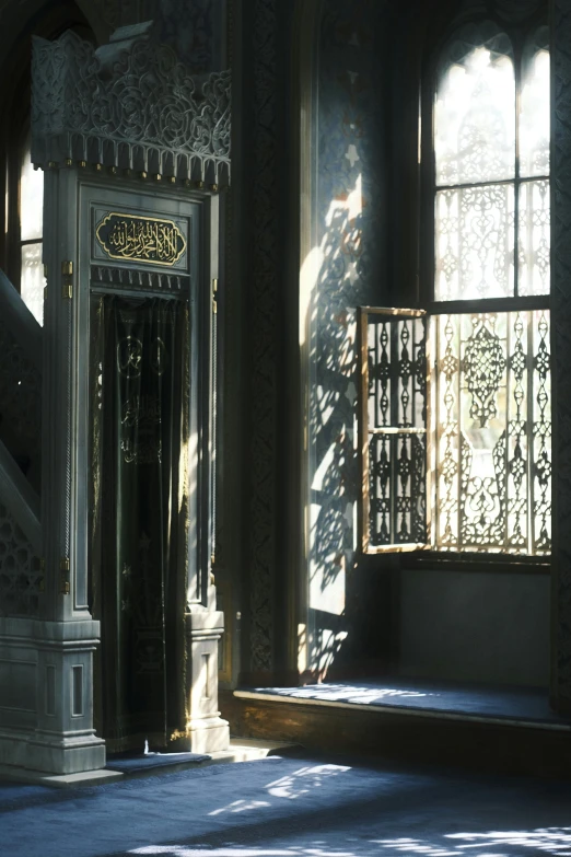 light shining in through two windows and onto a door with intricate paneling