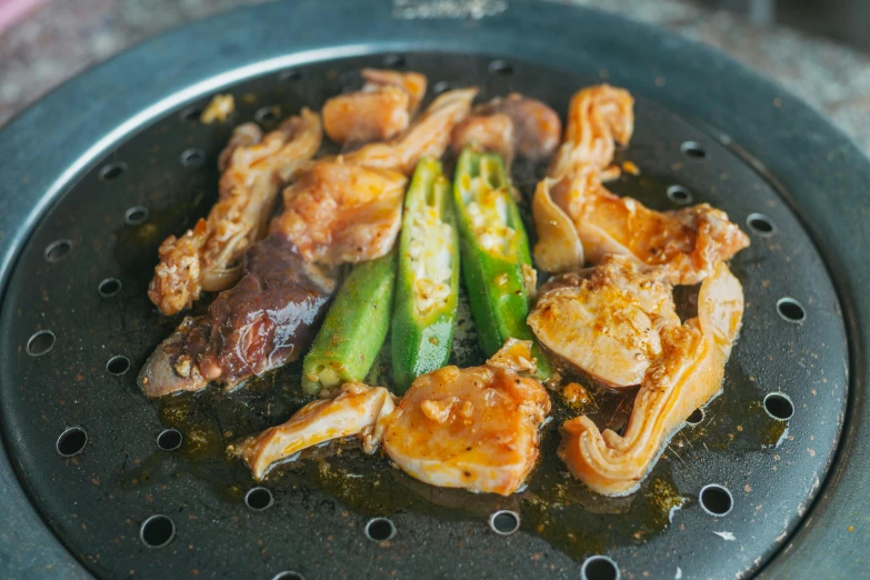 a bunch of food is being cooked on a frying pan