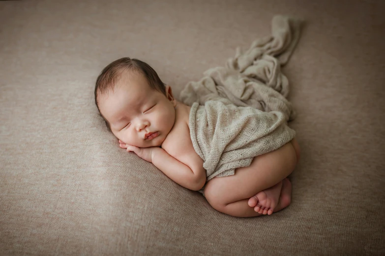 a baby asleep on its back curled up