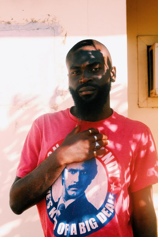 a man poses for the camera in a t - shirt