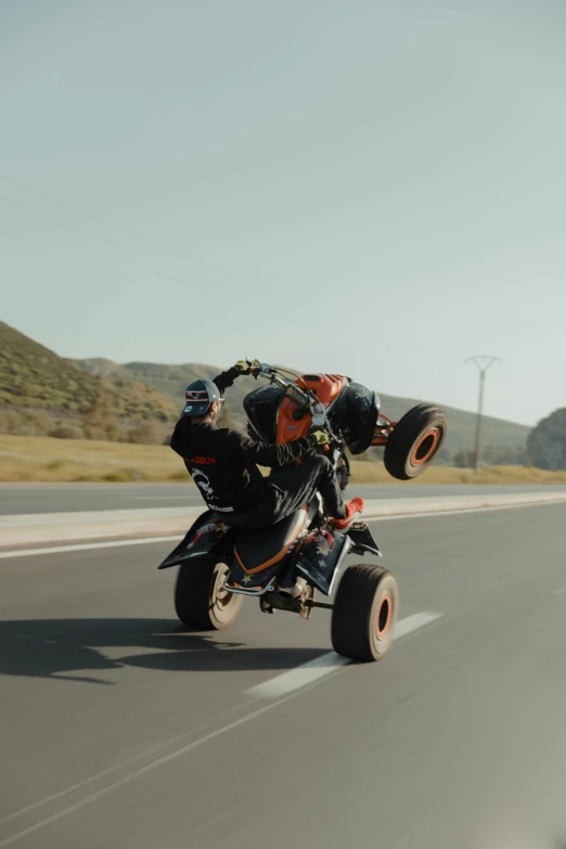 a person on a three wheeler driving down a street