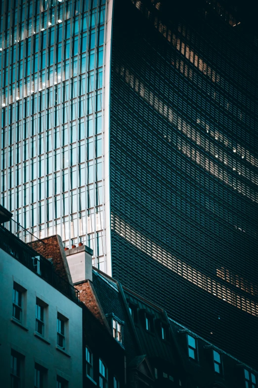 a very tall building that is sitting next to some buildings