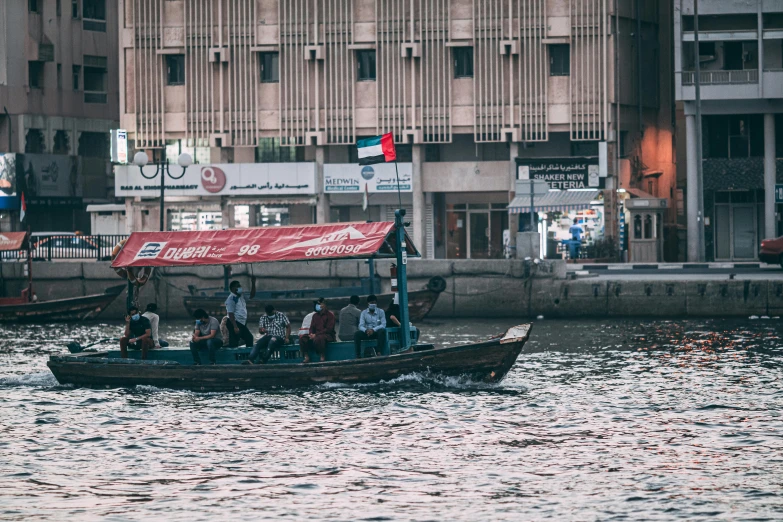 group of people hanging out on a boat in the water