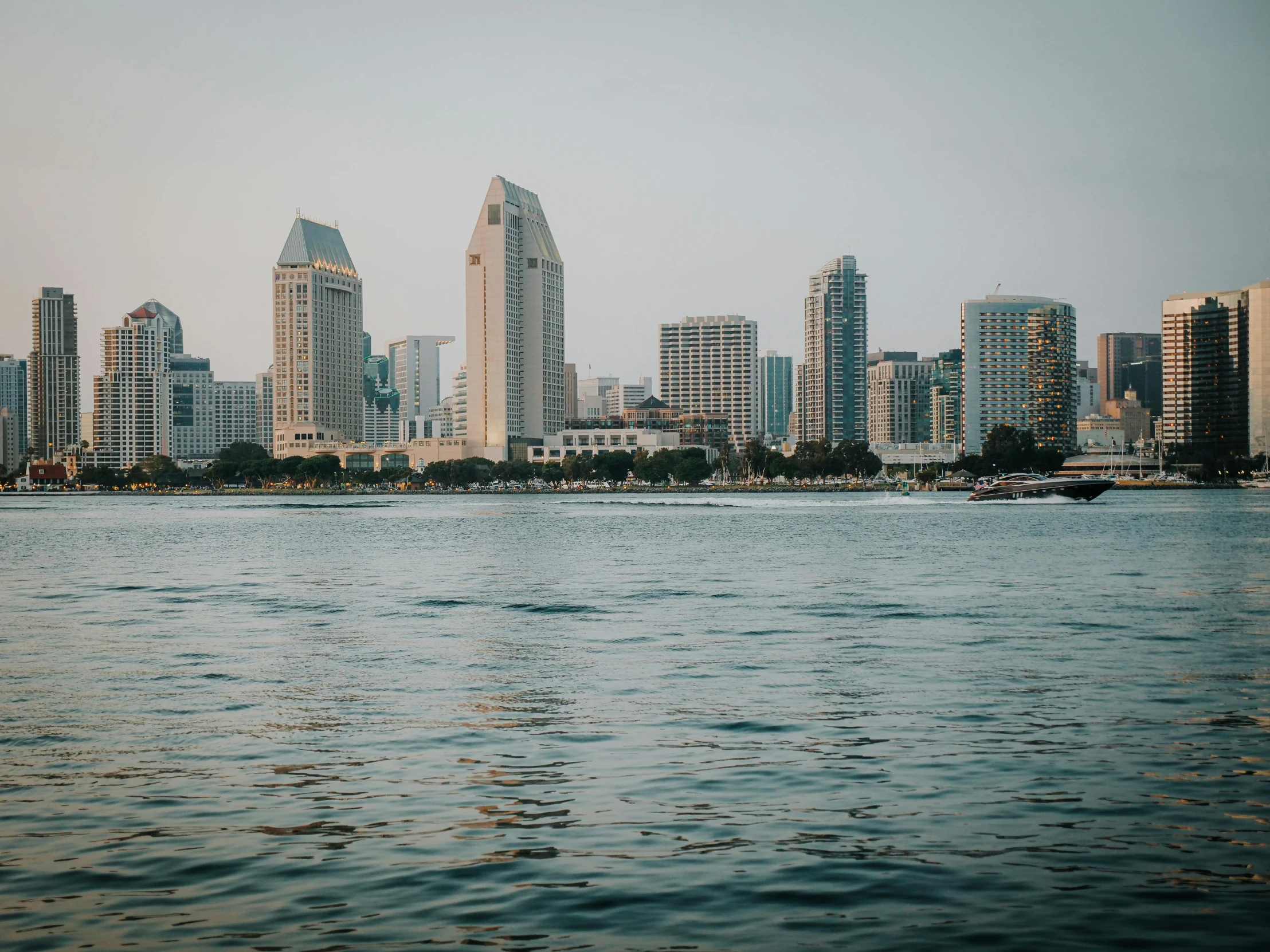 city skylines and large boats along the bay