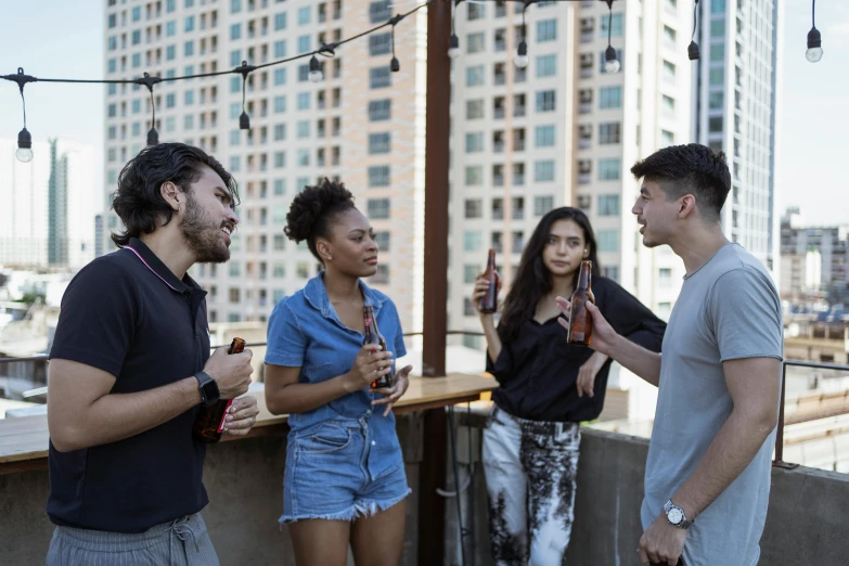 a group of young people hanging out together on a balcony