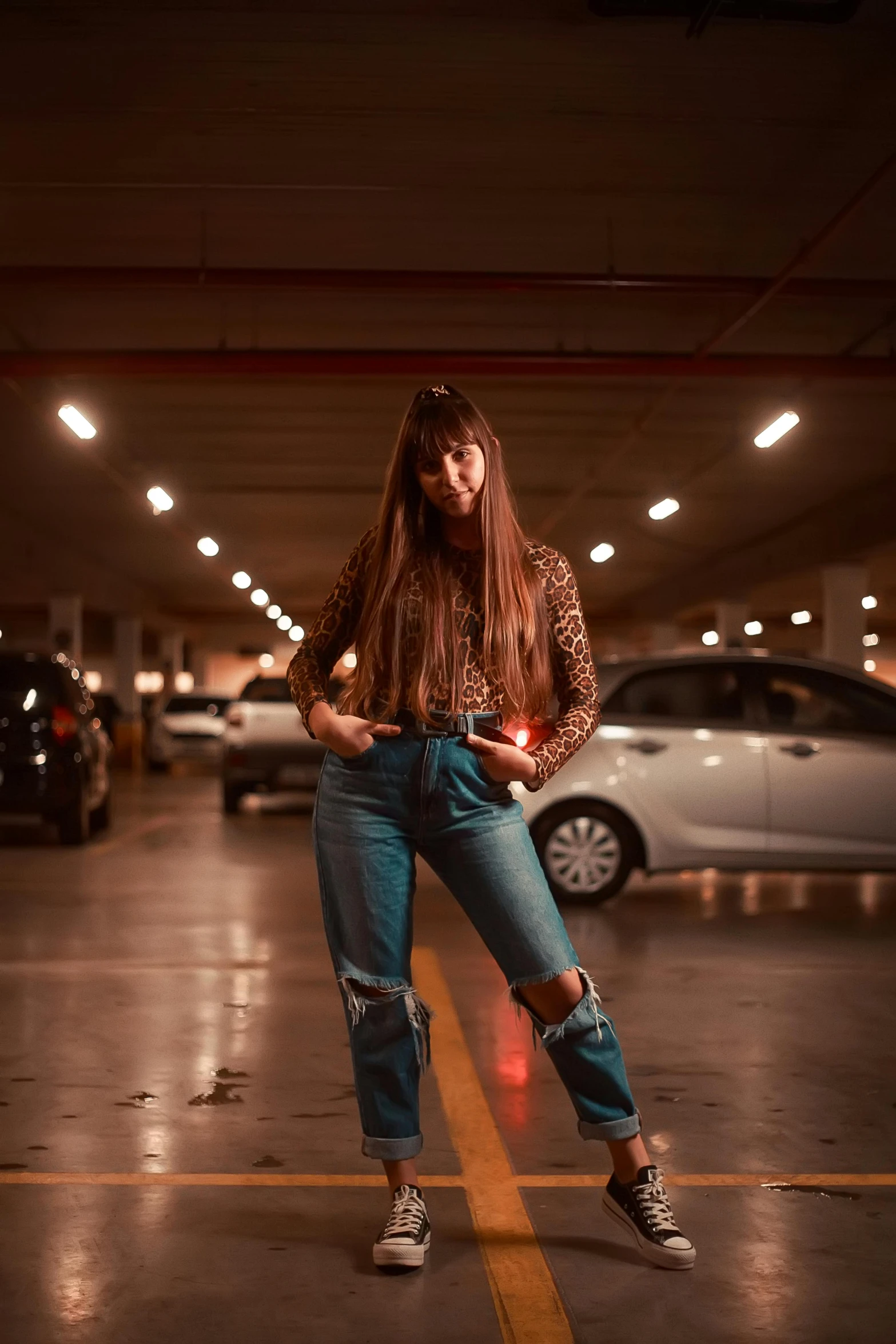 a woman in a parking lot leaning against a door