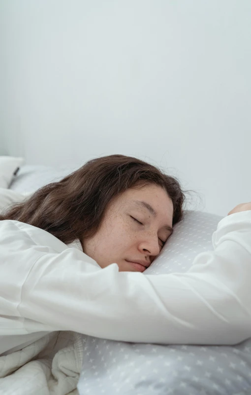 an image of a young woman that is sleeping