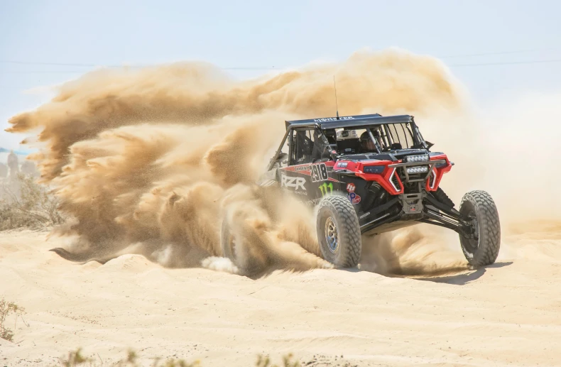 an atv riding down the desert in the desert