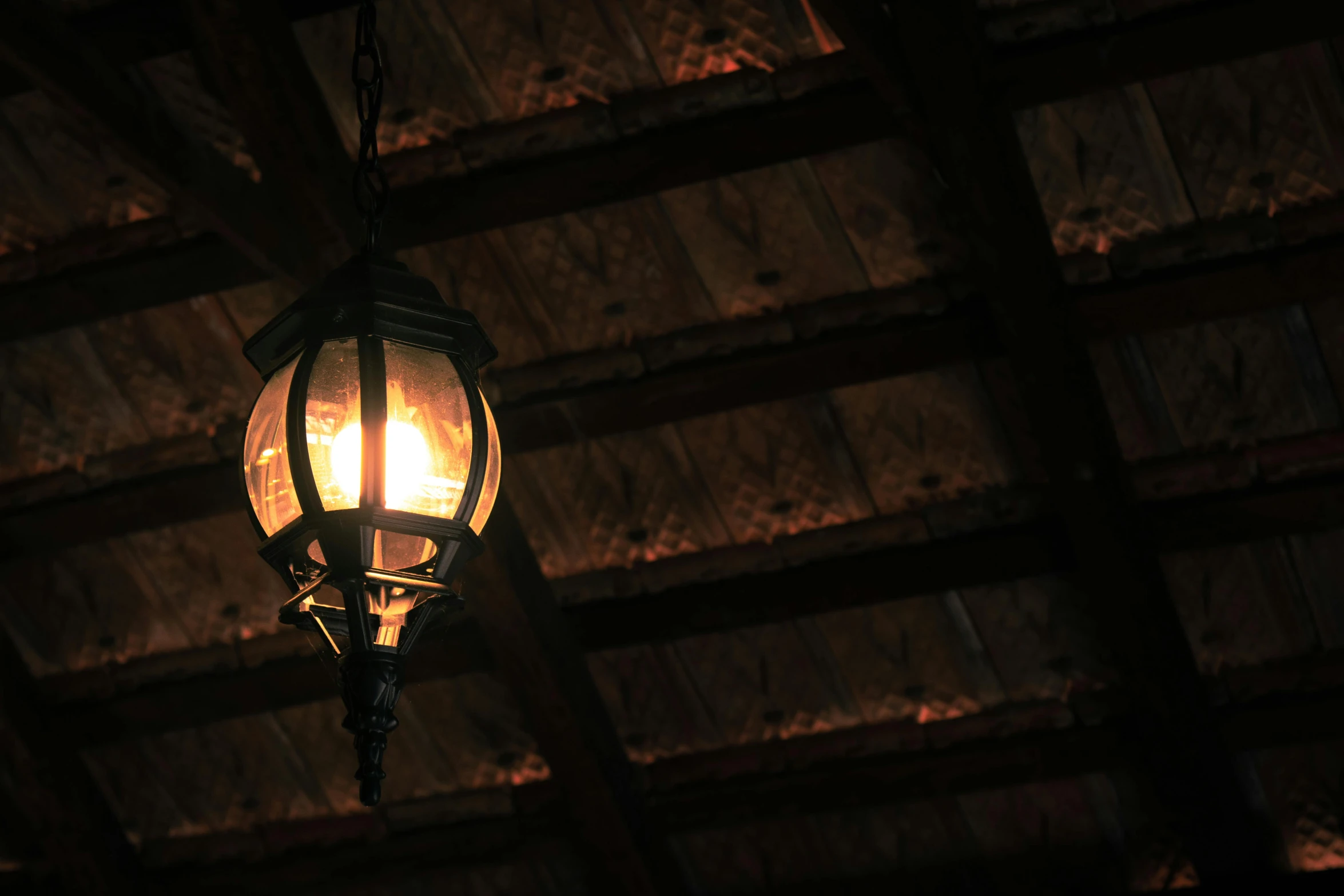 a lamp hanging from the ceiling of a building