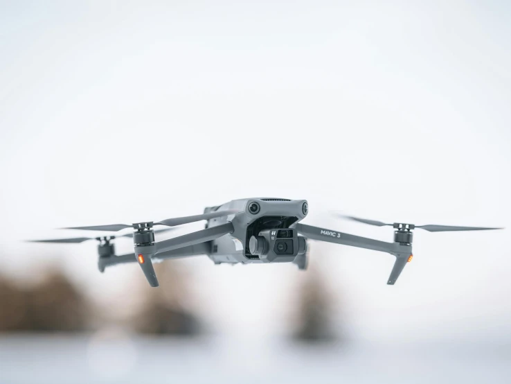 a very large, gray model flying over some water