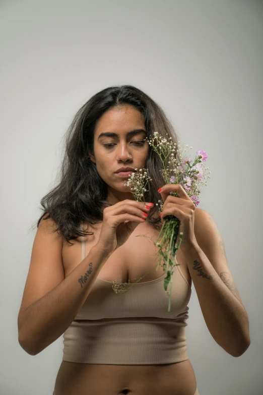 a girl holding flowers in her hands