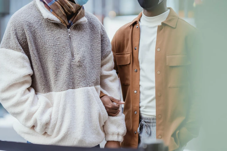 two men in jackets walking near each other