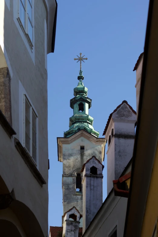 a steeple of a church, with a cross on the top