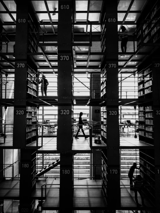 the view inside a liry with bookshelves and people