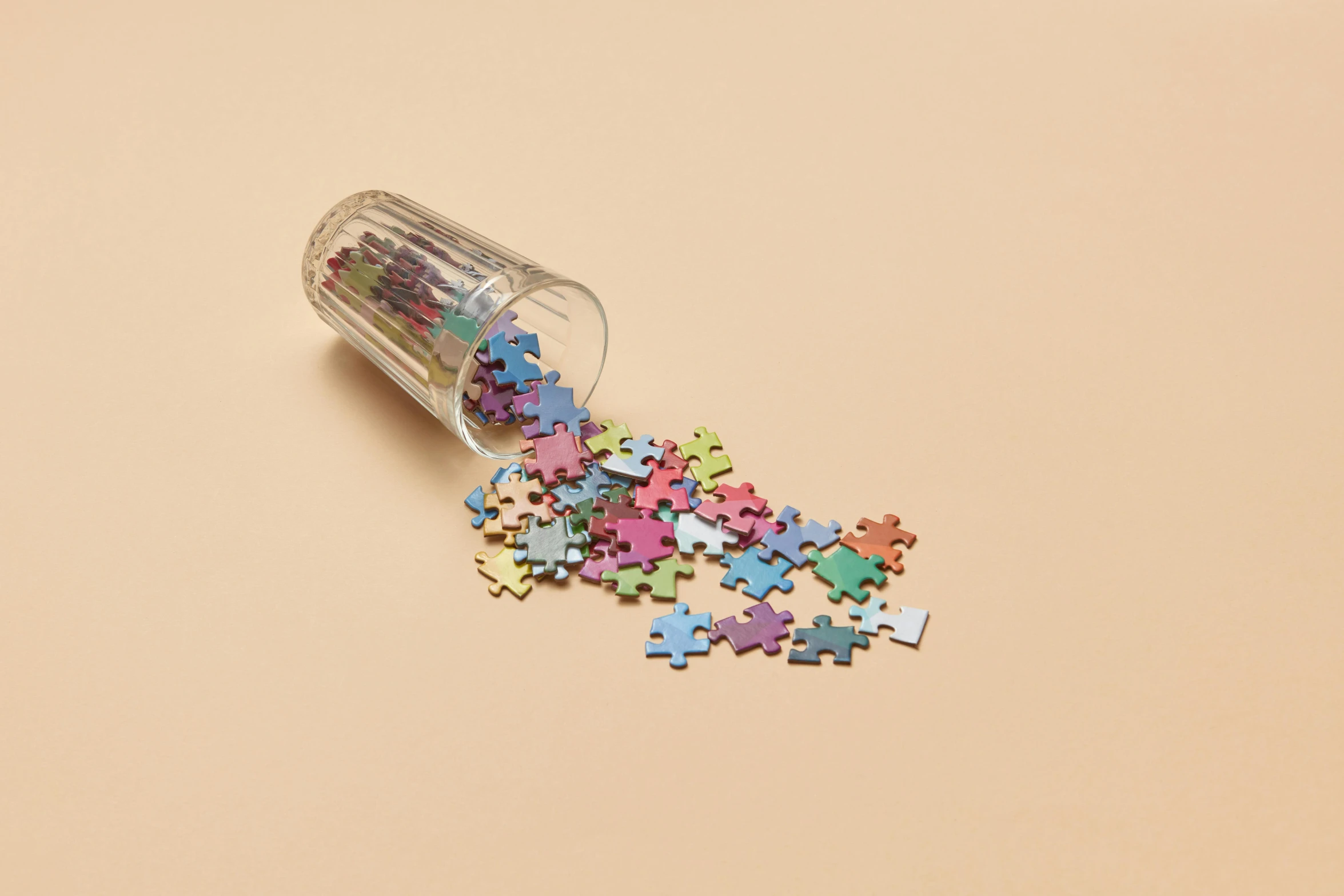 a small jar filled with assorted puzzle pieces