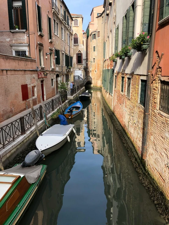 two boats parked next to each other on a canal