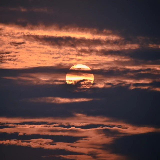 a sunset seen from a boat sailing on a body of water