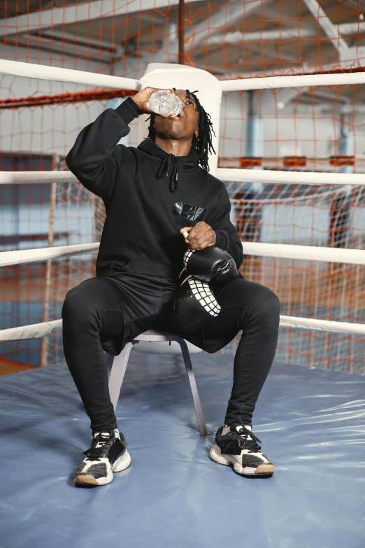 a man in a boxing ring looking up while sitting