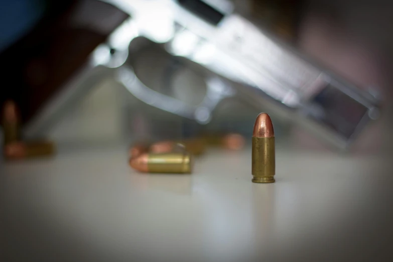 some gold bullet lying on a white table