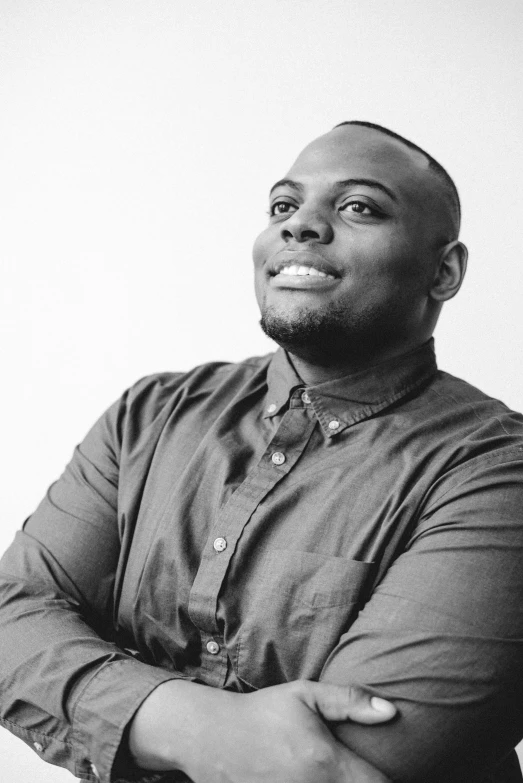 a man standing with his arms crossed looking up